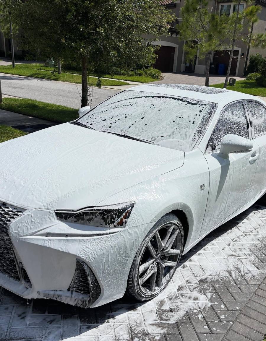 Foam pre-soak on a white Lexus IS in New Port Richey