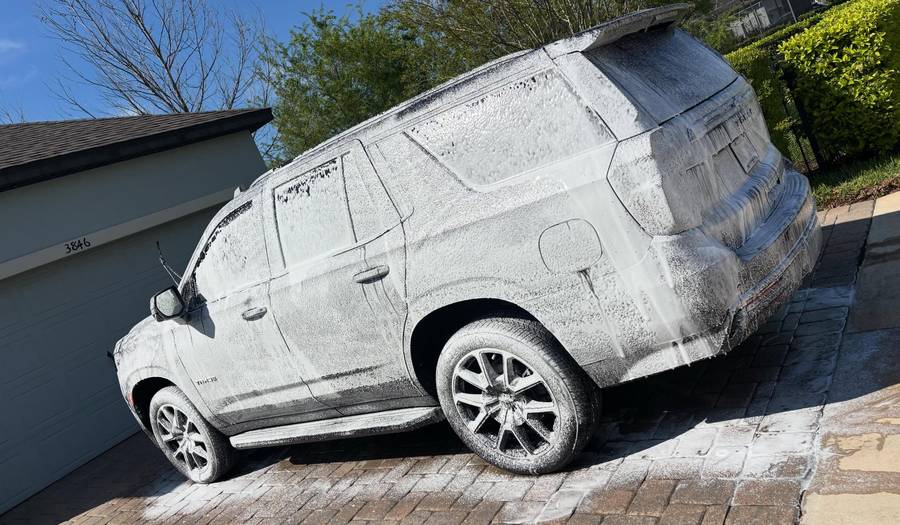 Full-size SUV in a thick foam bath during a Premier One wash