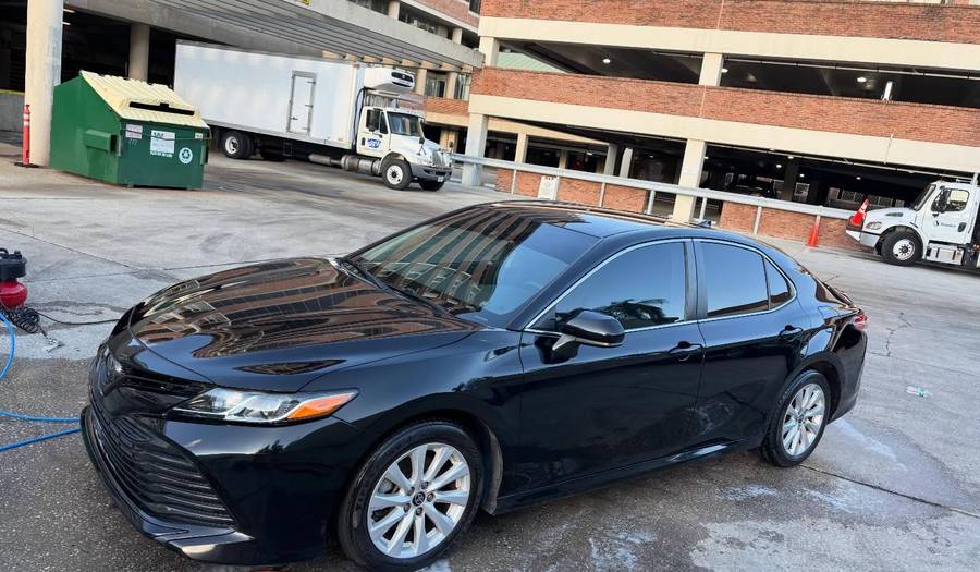 Black Toyota Camry detailed in a parking garage